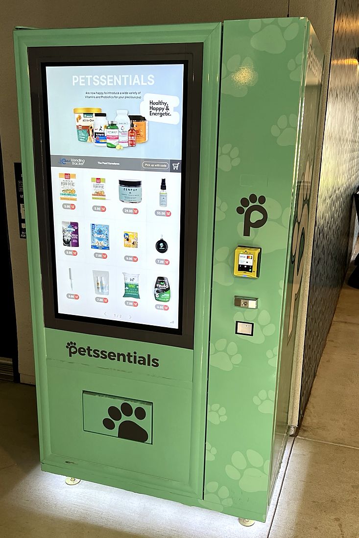 Mint green Petssentials Pet Hub at The Pearl, with a touchscreen showing vitamins and treats